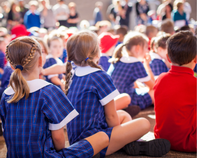 Shot of group of primary school children sat behind